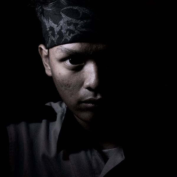 Silhouette of a man in a powerful stance against a light background.